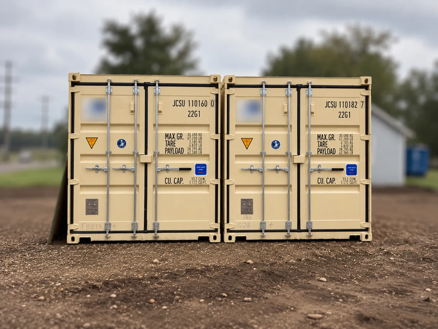 Two shipping containers on a gravel lot